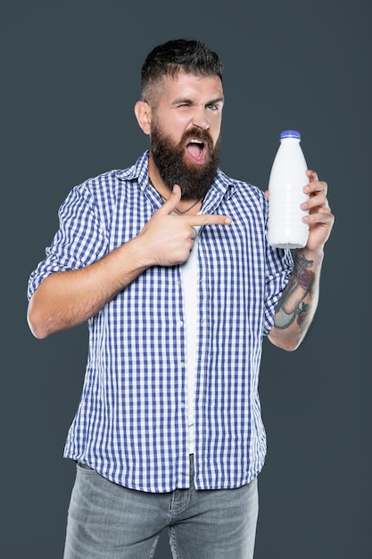 Man point finger on milk bottle for breakfast dairy product