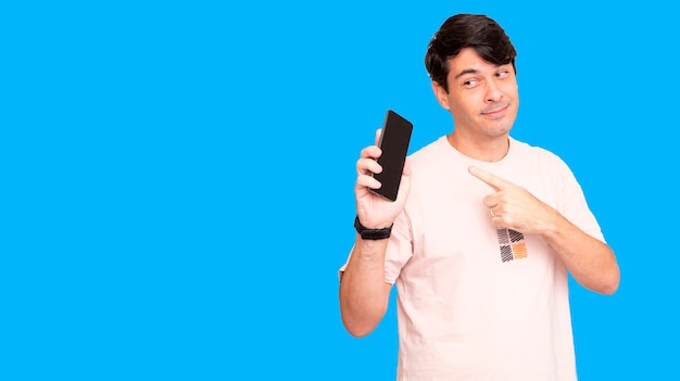 Man pointing to cell phone, and looking at it. Showing smartphone in hand.