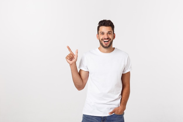 Man pointing showing copy space isolated. Casual handsome Caucasian young man.