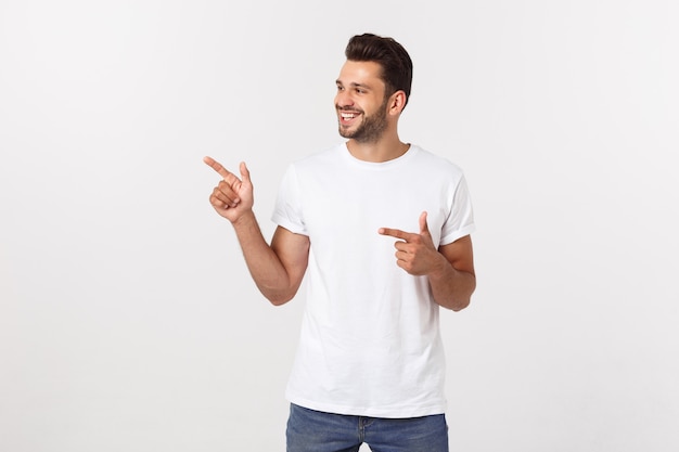 Man pointing showing copy space isolated. Casual handsome Caucasian young man.