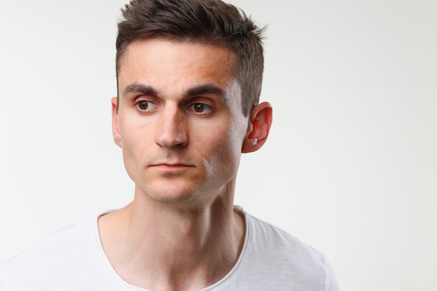 Man portrait cute in a white tank top on a gray background