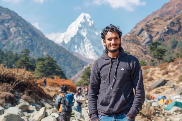 Man Posing Against Majestic SnowCapped Mountain Range