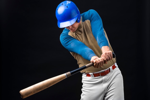 Man posing in helmet with baseball bat