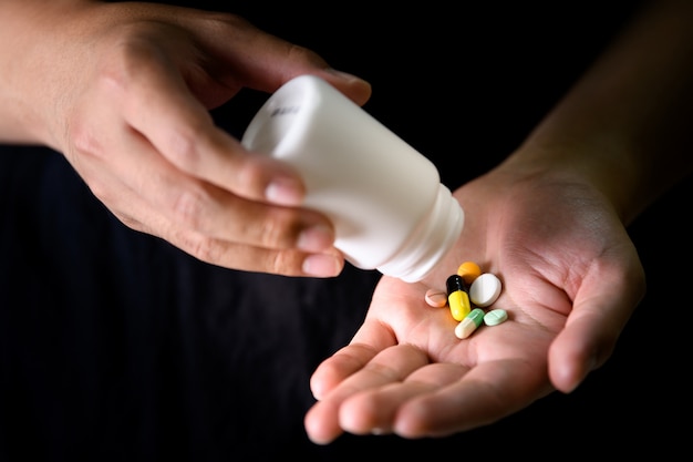 A man pour medicine on hand for treatment disease, medicine and drug 