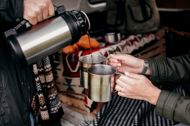 Man pouring coffee for his girlfriend