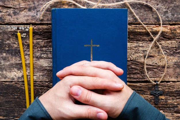 Man praying on the bible