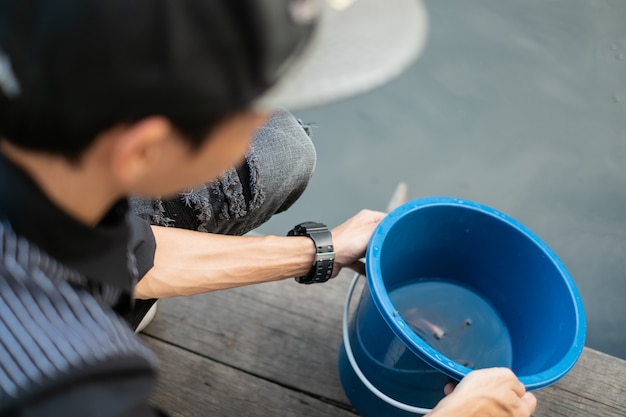 Man praying and free fish enjoying in river. The concept of hope