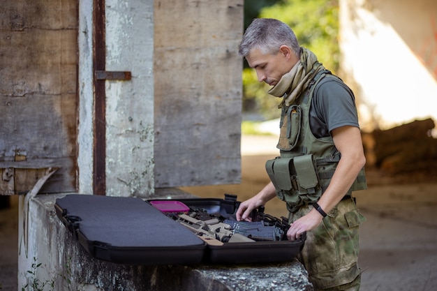 A man preparing for the airsoft game in military uniform