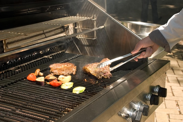 Man preparing barbecue in city cafe