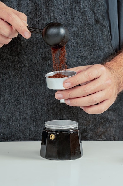 Man preparing classic Italian coffee in italian Moka coffee pot,