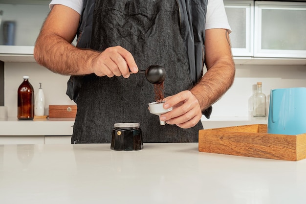 Man preparing classic Italian coffee in italian Moka coffee pot,