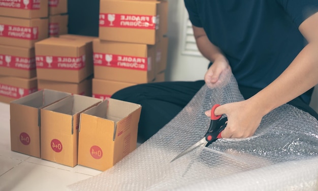 man preparing a parcel for delivery at online selling business office Ecommerce drop shipping