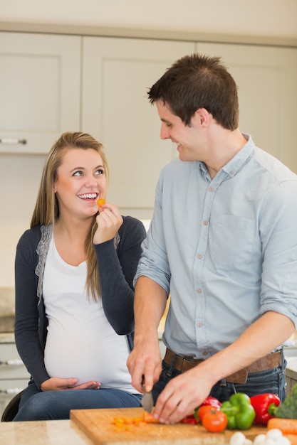 Man preparing vegetables for pregnant wife