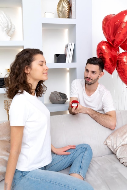 A man presents the engagement ring to his girlfriend Valentines day celebration