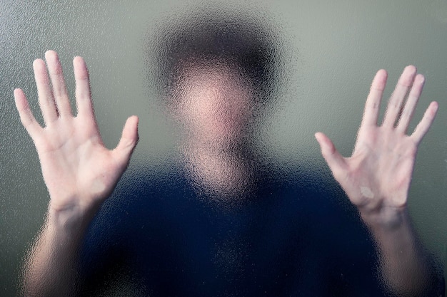 Man pressing his palms to a screen