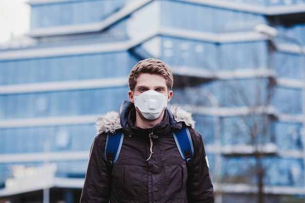 Man in protective mask against transmissible infectious diseases