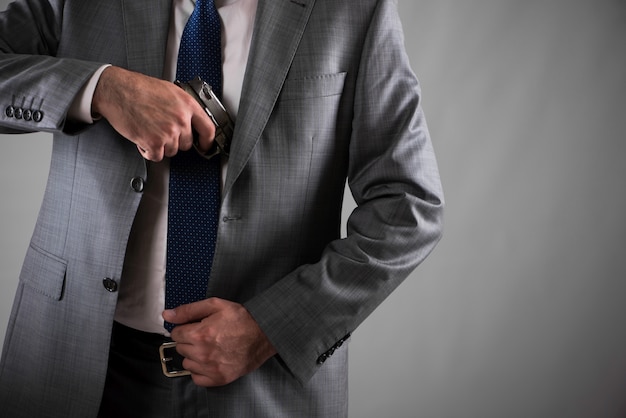 Man pulling out gun from his pocket