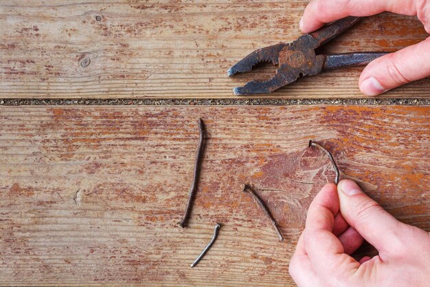 Man pulls out the old nails from the floor