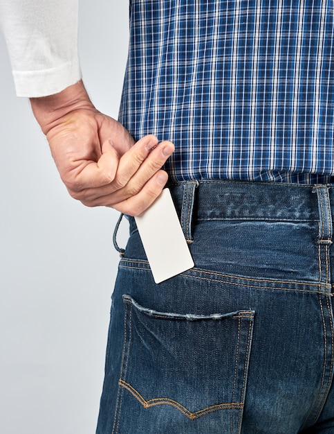 Man puts an empty blank paper business card