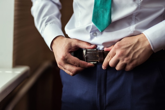 Man putting on a belt, Businessman, Politician, man's style, male hands closeup,  businessman,  businessman, a businessman from Asia, People, business, fashion and clothing concept