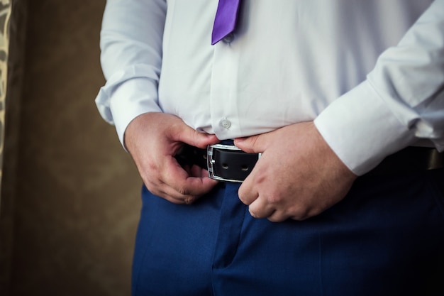 Man putting on a belt, Businessman, Politician, man's style, male hands closeup,  businessman,  businessman, a businessman from Asia, People, business, fashion and clothing concept