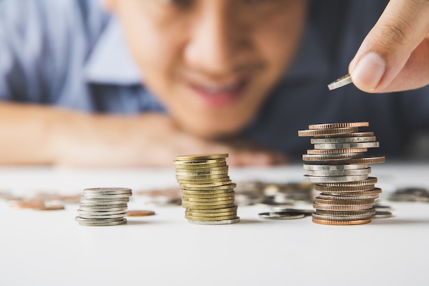 Man putting coin on stack