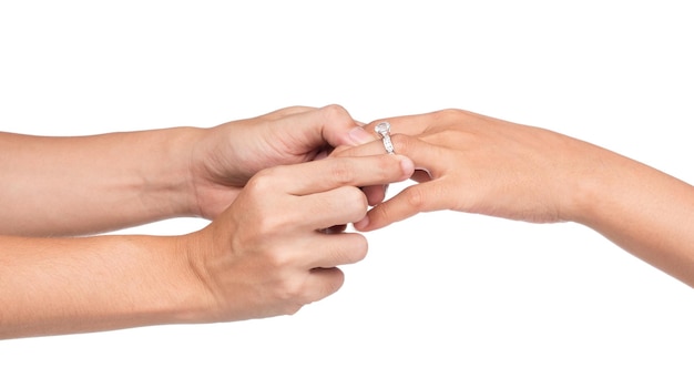 Man putting engagement ring on woman hand isolate on white background