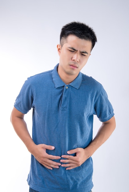 Man putting his hands on belly concept of stomachache on white background