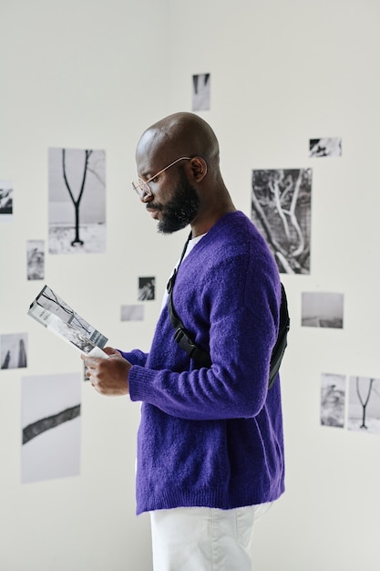 Man reading booklet at gallery