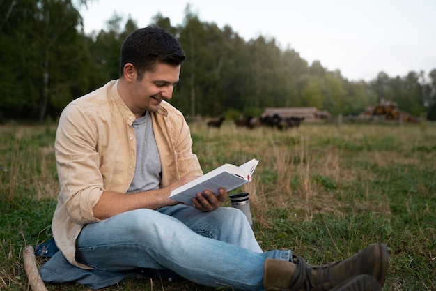 Man reading outdoors side view