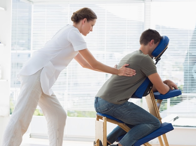 Man receiving back massage from physiotherapist