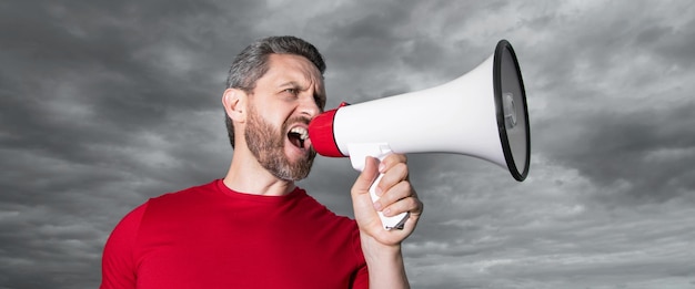 Photo man in red shirt scream in loudspeaker on sky background