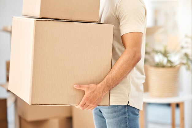 Photo man relocation and moving with boxes in arms property investment and real estate for new home tenant asset packages and rental loan or mortgage residential apartment and carrying cardboard