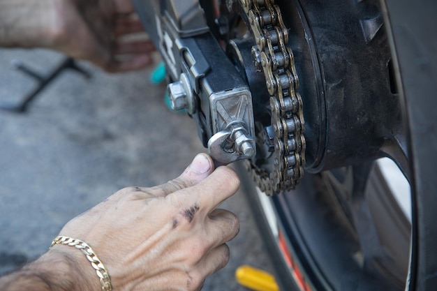 Man repairing motorcycle chain Sport Hobby