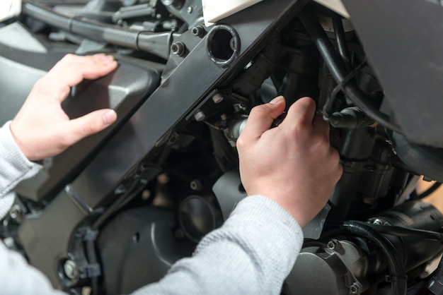 Man repairing the motorcycle, close  up