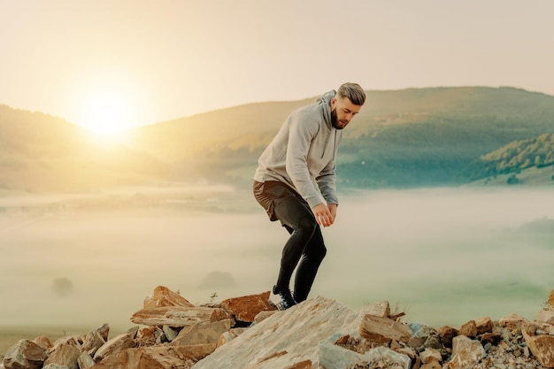 Man rest on top of mount after morning training