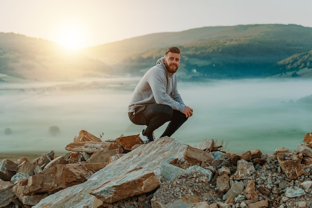 Man rest on top of mount after morning training