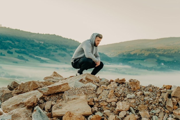 Man rest on top of mountain after training.Motivation concept