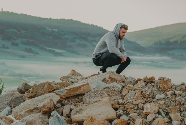 Man rest on top of mountain after training.Motivation concept