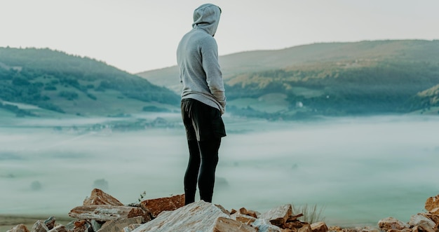 Man rest on top of mountain after training.Motivation concept