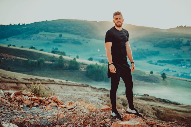 Man rest on top of mountain after training.Motivation concept