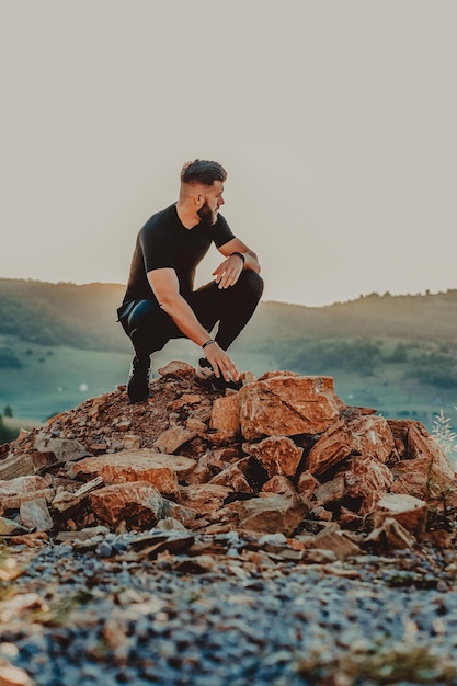 Man rest on top of mountain after training.Motivation concept