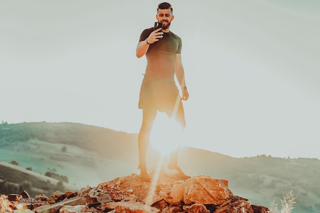 Man rest on top of mountain after training.Motivation concept