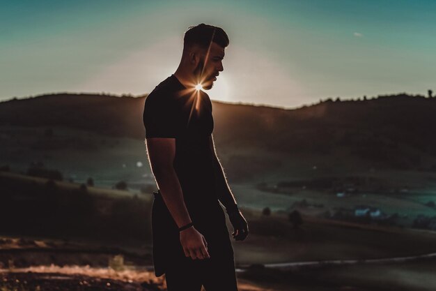 Man rest on top of mountain after training.Motivation concept