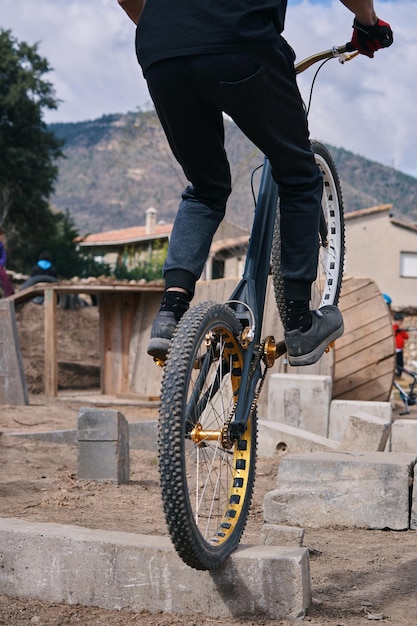 A man rides a bike with the word " ride " on the front wheel.