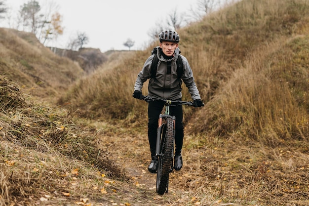 Man riding a bike on mountain path