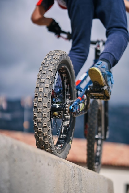 A man riding a bike with a large wheel on the front