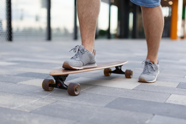 man riding longboard selective focus on boy's foot Lifestyle and sport concept