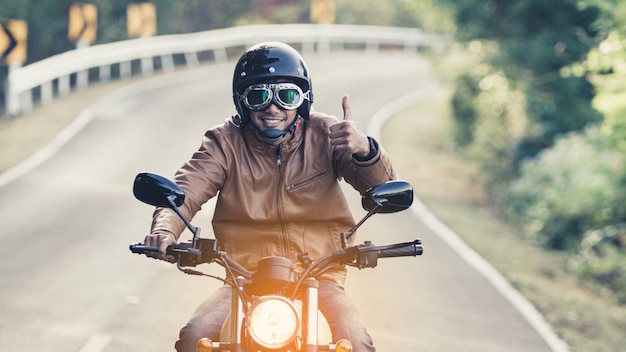 man riding motorbike on a road in freedom lifestyle at vacation time