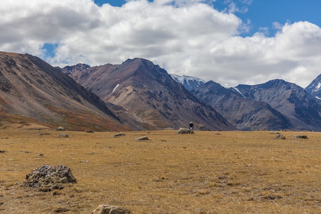 Man riding a motorbike in the steppes of Mongolia, on the hills of Mongolia